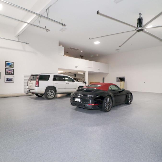 Barndominium Garage View With Ceiling Fan and Two Cars